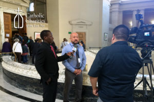 Christopher Martinez speaks to the press, advocating for renewed funding for legal services to unaccompanied minors.