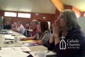 Debra Gunn (foreground) and Stephen Mullin (center) listen carefully to the presentation.