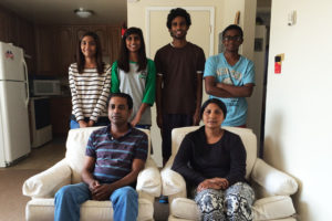 Ghafoor and Teressa Shahzad with their children in their new home.