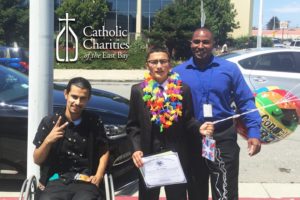 Javier Arongo (l) and Gimone Bryant (r) celebrate Abel's graduation from 8th Grade.