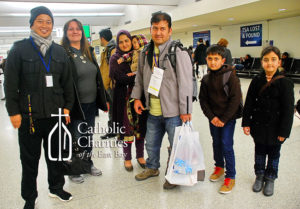 Refugee Resettlement Program case workers welcome refugees at the airport.